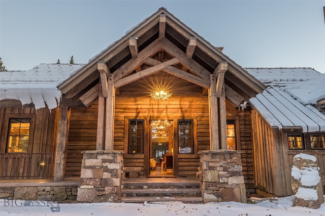 view of snow covered property entrance