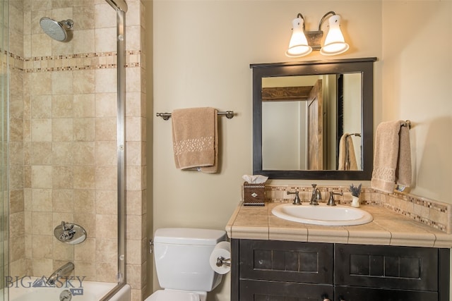 full bathroom with vanity, toilet, and bath / shower combo with glass door