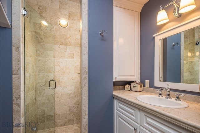 bathroom with vanity and a shower with shower door