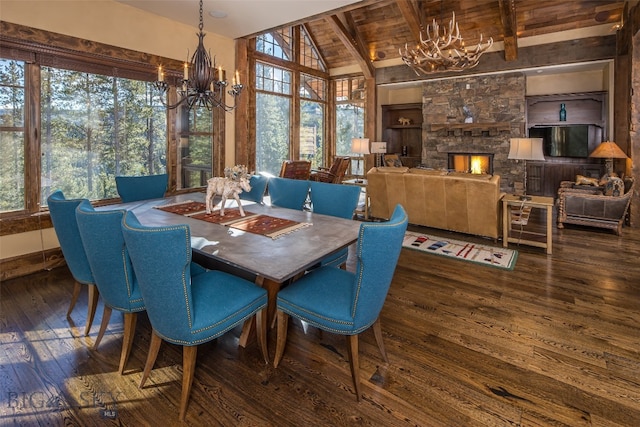 dining area with dark hardwood / wood-style flooring, plenty of natural light, and a stone fireplace