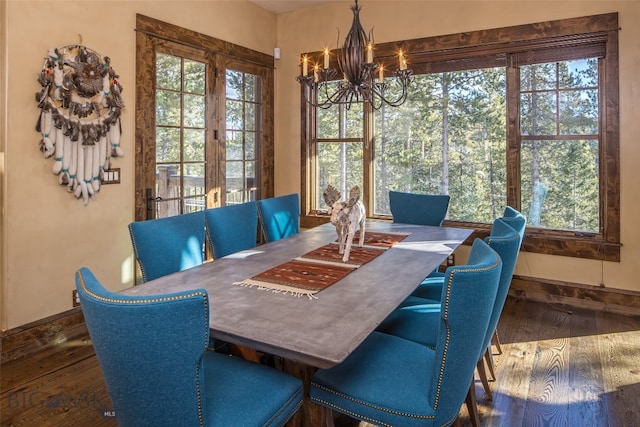 dining space featuring a notable chandelier and dark hardwood / wood-style floors