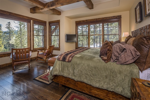 bedroom with beam ceiling, multiple windows, and dark wood-type flooring