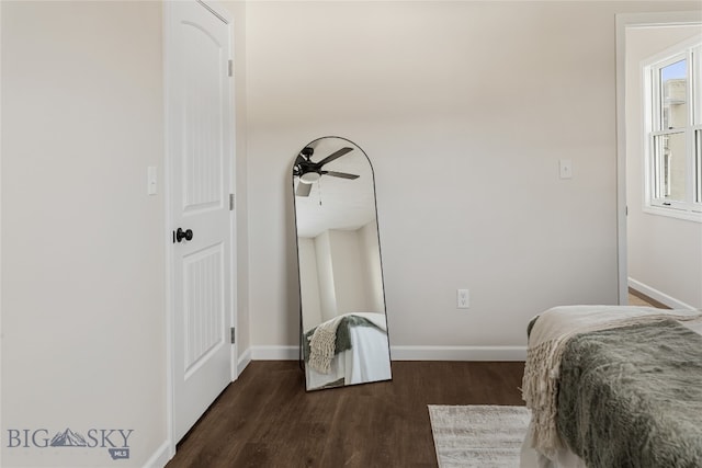 bedroom with ceiling fan and dark wood-type flooring