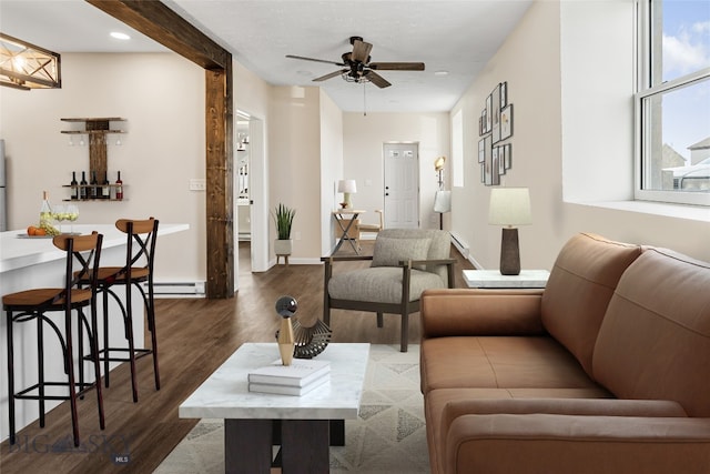 living room with ceiling fan and dark hardwood / wood-style flooring