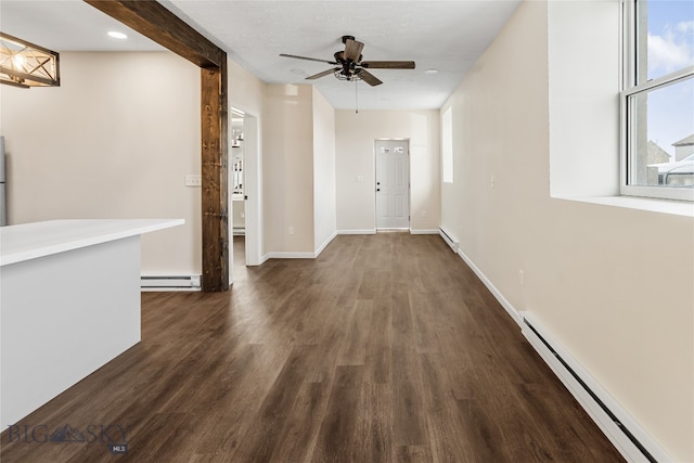 corridor featuring dark wood-type flooring and a baseboard heating unit