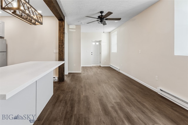 hall featuring dark wood-type flooring, a textured ceiling, and a baseboard heating unit