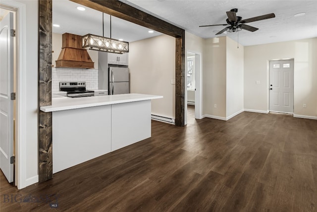 kitchen with appliances with stainless steel finishes, ceiling fan, pendant lighting, a baseboard radiator, and white cabinetry