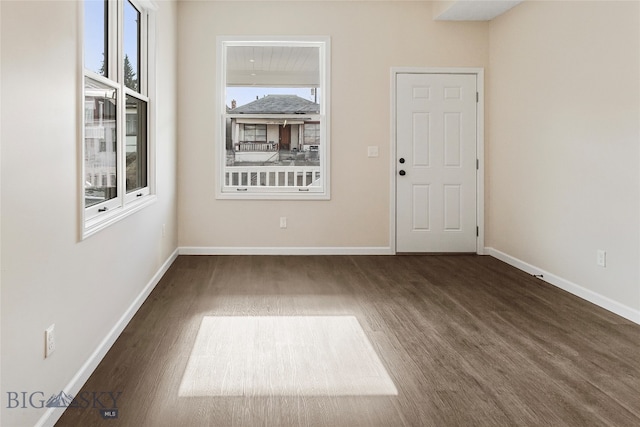 unfurnished room featuring dark wood-type flooring