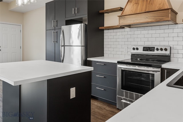 kitchen with decorative backsplash, dark hardwood / wood-style flooring, custom range hood, and stainless steel appliances