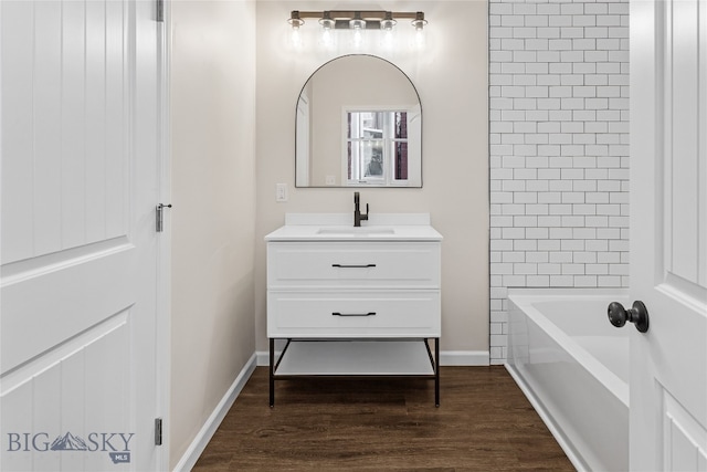 bathroom with vanity, tiled shower / bath combo, and hardwood / wood-style flooring