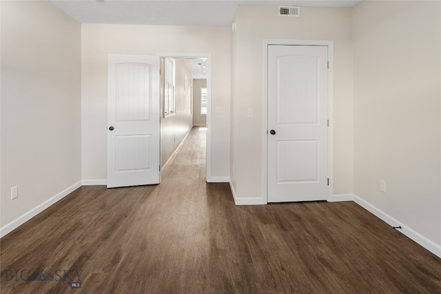 empty room featuring dark wood-type flooring