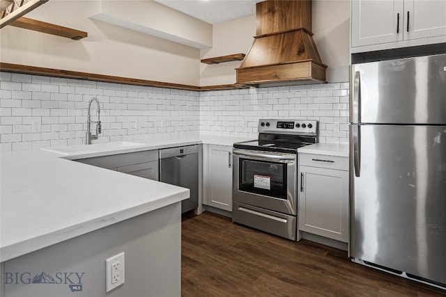 kitchen featuring gray cabinets, decorative backsplash, dark hardwood / wood-style flooring, and appliances with stainless steel finishes