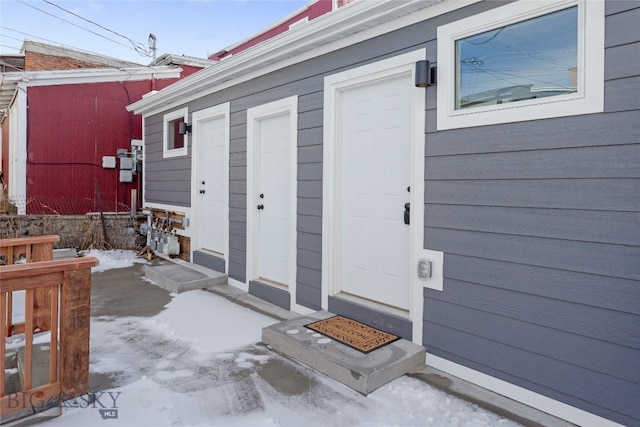 view of snow covered property entrance