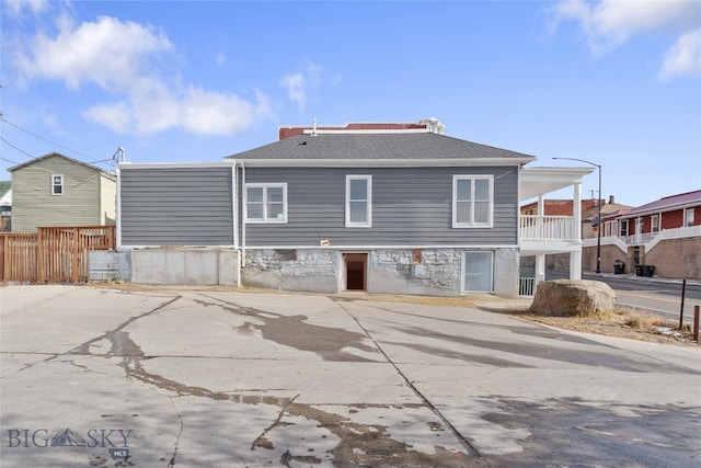 rear view of property featuring a balcony