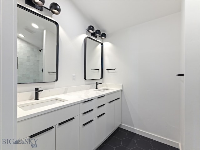 bathroom with tile patterned floors, vanity, and lofted ceiling