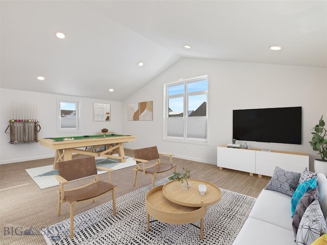 living room featuring lofted ceiling and hardwood / wood-style flooring