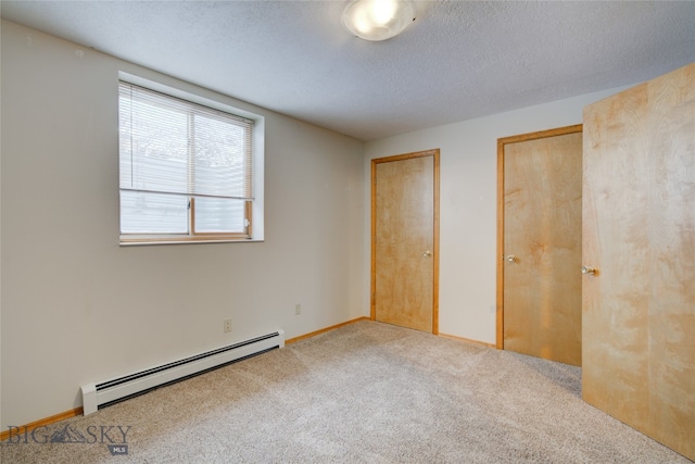 unfurnished bedroom featuring carpet, a textured ceiling, and a baseboard radiator