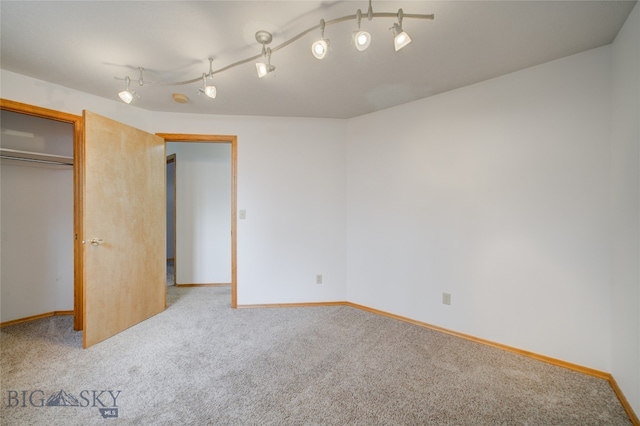 unfurnished bedroom featuring a closet and light colored carpet