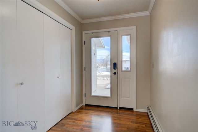 entryway featuring wood-type flooring, ornamental molding, and a baseboard radiator