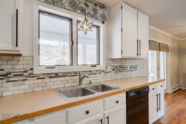 kitchen with sink, dishwasher, light hardwood / wood-style floors, white cabinetry, and hanging light fixtures