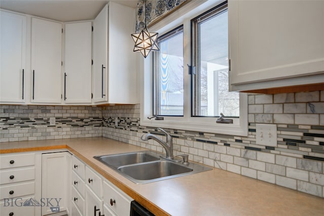 kitchen with pendant lighting, a healthy amount of sunlight, white cabinetry, and sink