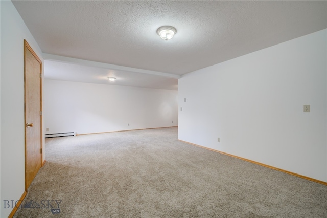 empty room featuring baseboard heating, carpet floors, and a textured ceiling