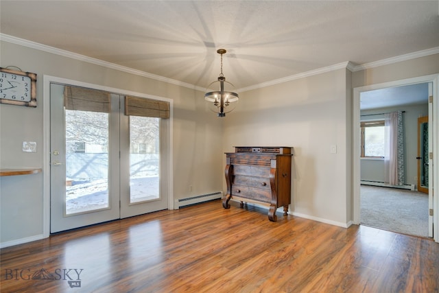 interior space with ornamental molding, a baseboard radiator, a notable chandelier, and wood-type flooring