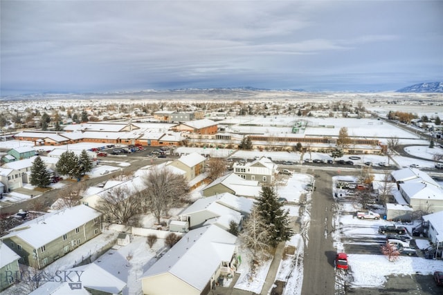 snowy aerial view with a mountain view