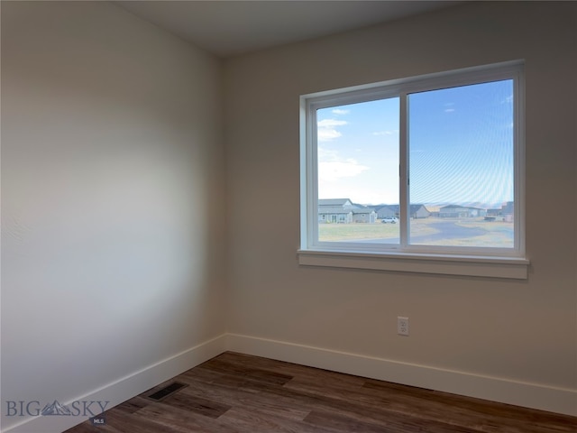 empty room featuring dark wood-type flooring