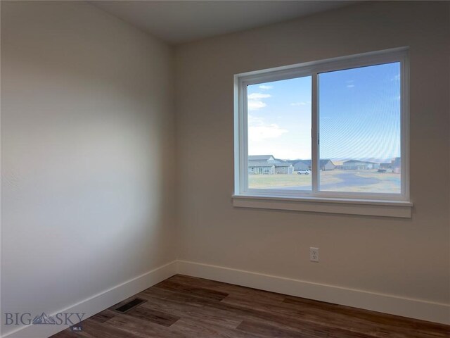 206 Otis Ave, Ennis, MT 59729 - empty room with baseboards and dark wood-type flooring