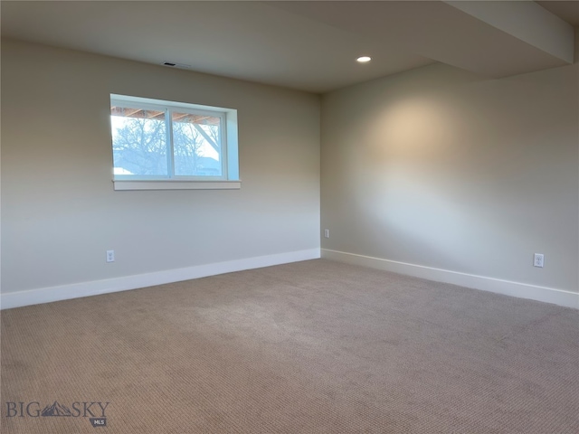 spare room featuring light colored carpet