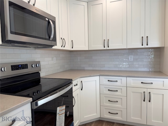 kitchen with white cabinets, backsplash, dark hardwood / wood-style flooring, and stainless steel appliances