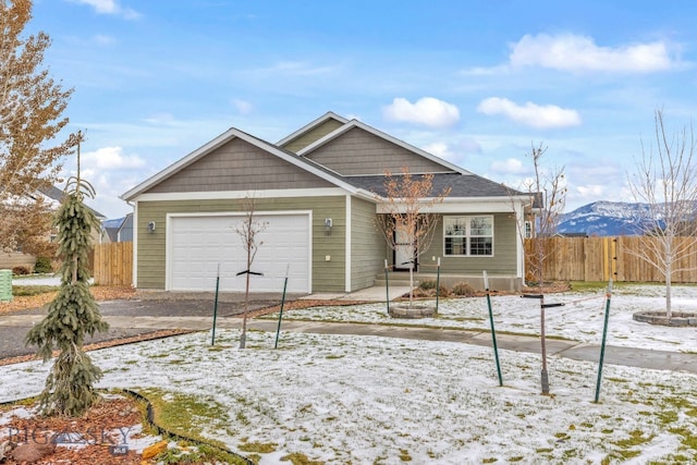 view of front of home with a mountain view and a garage