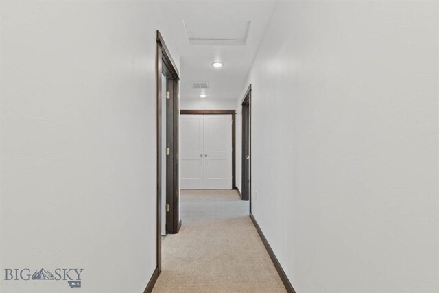 corridor with light colored carpet