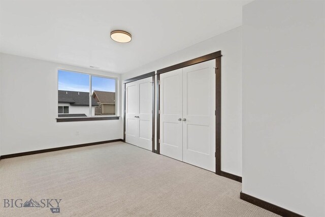 unfurnished bedroom with light carpet