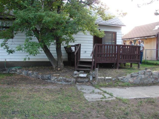 back of house with a wooden deck