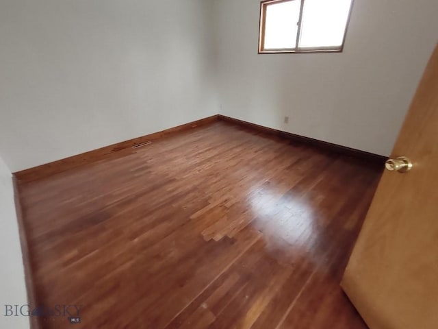 empty room featuring hardwood / wood-style flooring