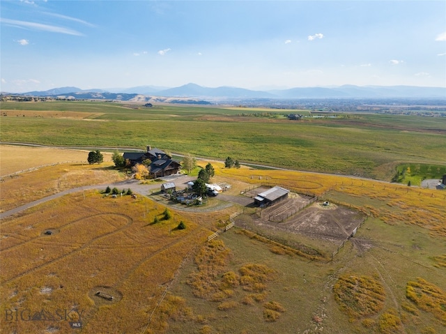 birds eye view of property with a mountain view and a rural view