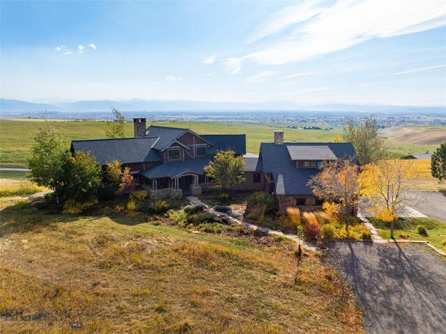 drone / aerial view featuring a mountain view and a rural view