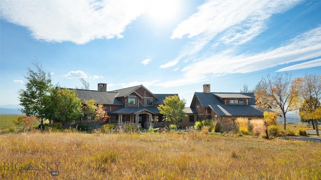 618 Autumn Ridge Rd, Bozeman, MT 59715 - view of front facade with a chimney and stone siding