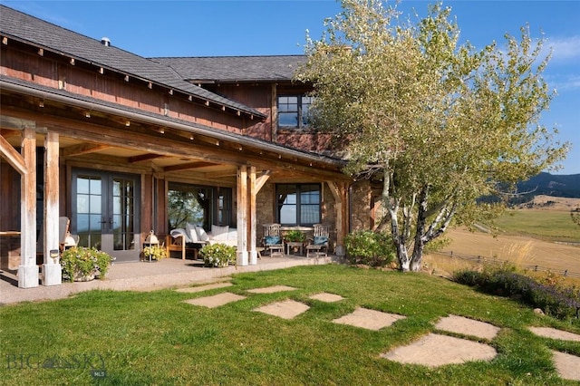 618 Autumn Ridge Rd, Bozeman, MT 59715 - back of property featuring a patio area, a lawn, and french doors