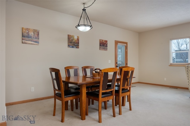 dining space with light colored carpet