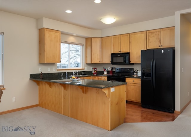 kitchen with kitchen peninsula, sink, light colored carpet, and black appliances