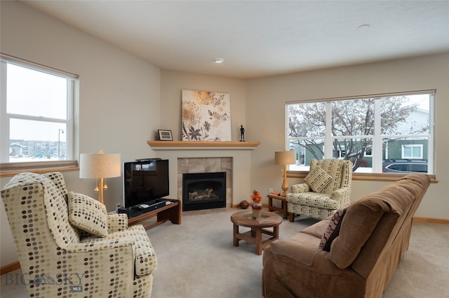 carpeted living room featuring a healthy amount of sunlight and a tile fireplace