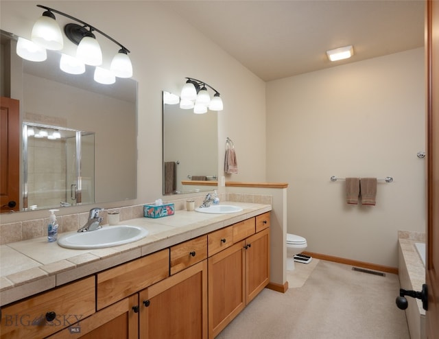 bathroom featuring vanity, toilet, and an enclosed shower