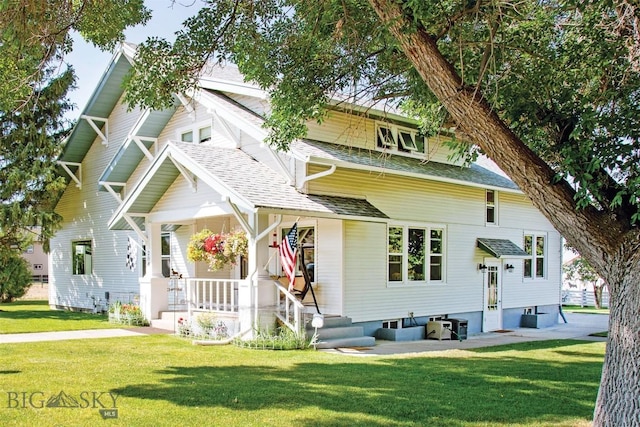 204 Boundary St, Sheridan, MT 59749 - view of front of home featuring a front yard, roof with shingles, and covered porch