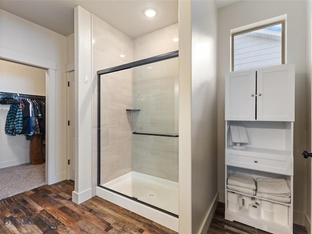 bathroom with hardwood / wood-style floors and walk in shower