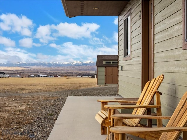 view of patio with a storage unit and an outbuilding