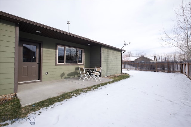 yard covered in snow featuring a patio area