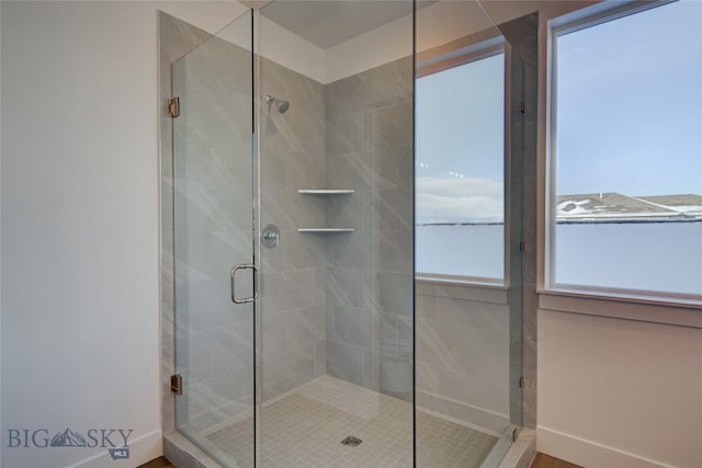 bathroom with a shower with door